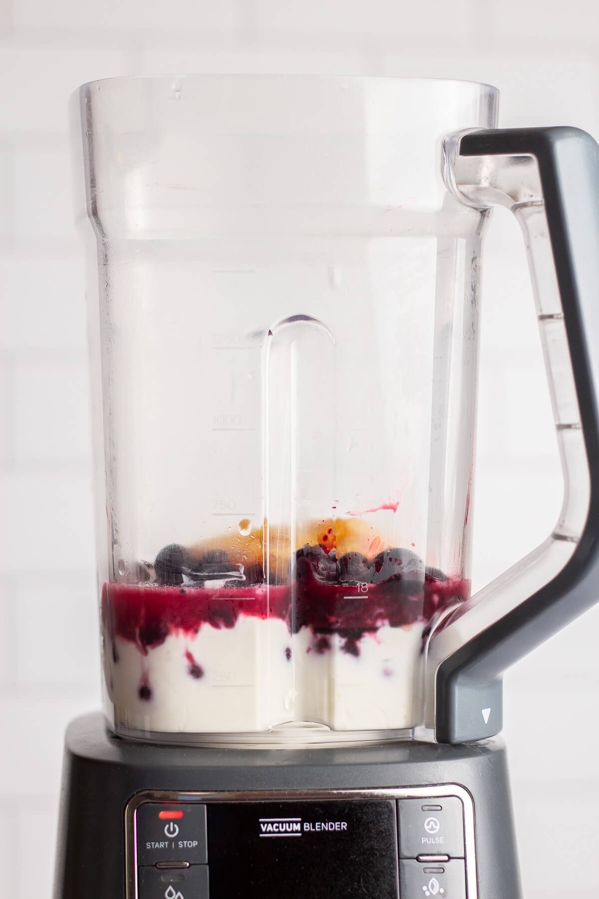 ingredients for blueberry yogurt smoothie in a blender